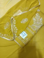 Mustard yellow cotton dress material featuring white hand work embroidery on front panel