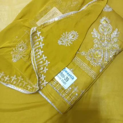 Mustard yellow cotton dress material featuring white hand work embroidery on front panel